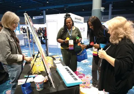 Attendees ring their bells at Sententia Gamification’s GamiCon booth. PHOTOGRAPHY BY HUGHES FIORETTI PHOTOGRAPHY