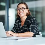 woman sitting at a desk with her computer.