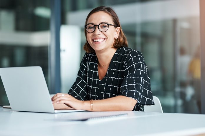 woman sitting at a desk with her computer.