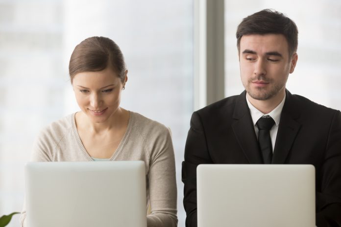 Inquisitive,Curious,Businessman,With,Bad,Manners,Sneakly,Looking,At,Laptop