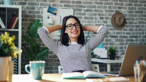Woman sitting back in a desk chair